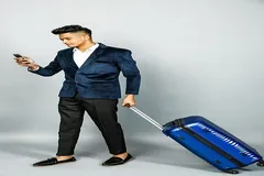 Bavulunu çeken yolcu ve telefonu